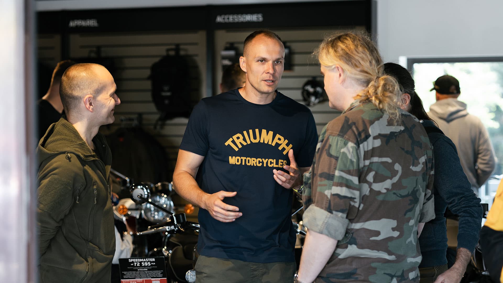 Triumph employee speaking to people on opening day