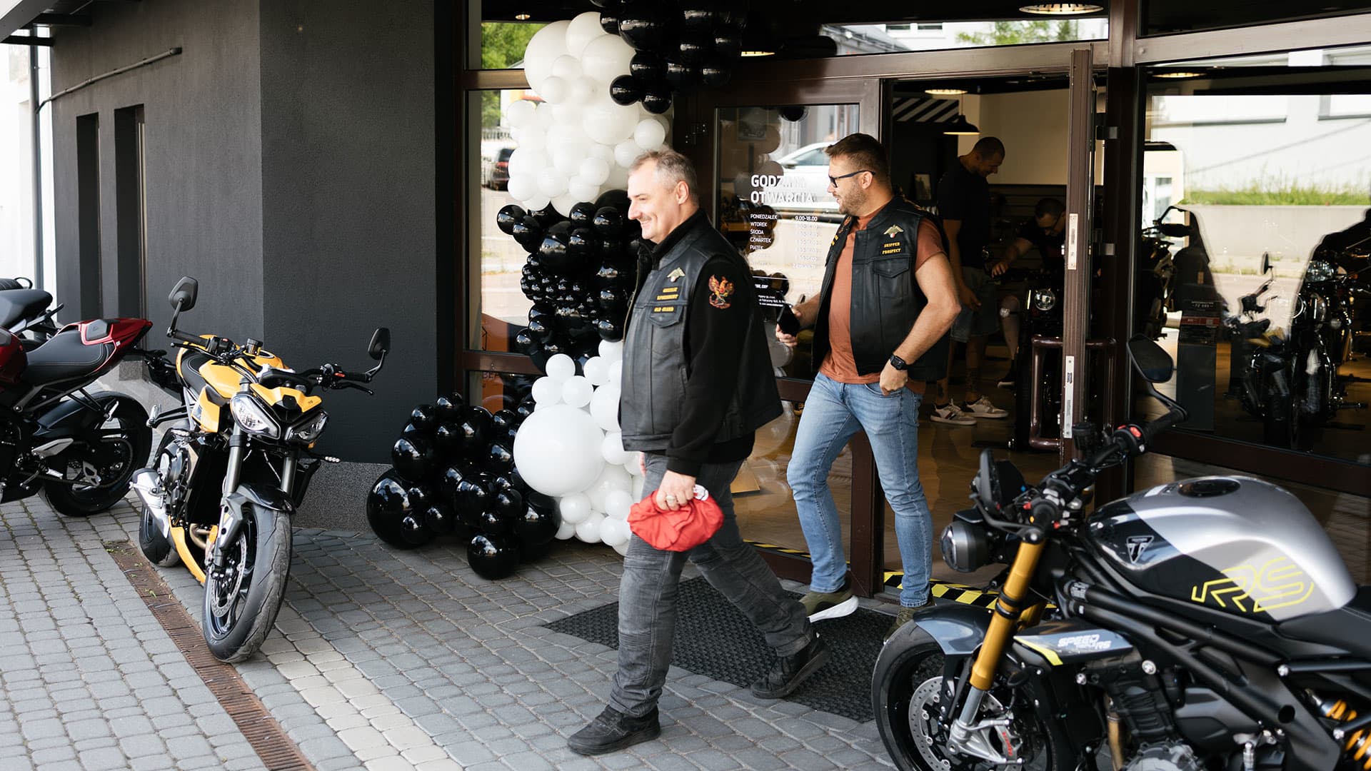 Customers walking out of the new Triumph dealership in Poland