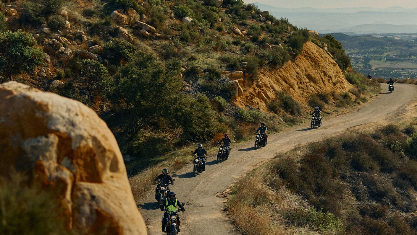 Triumph motorcycles riding through mountainous road