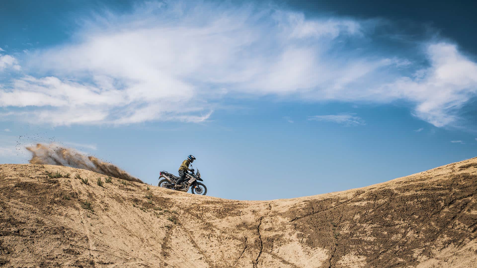 A solo rider on the Triumph Tiger 800 XCA along the desert ridge