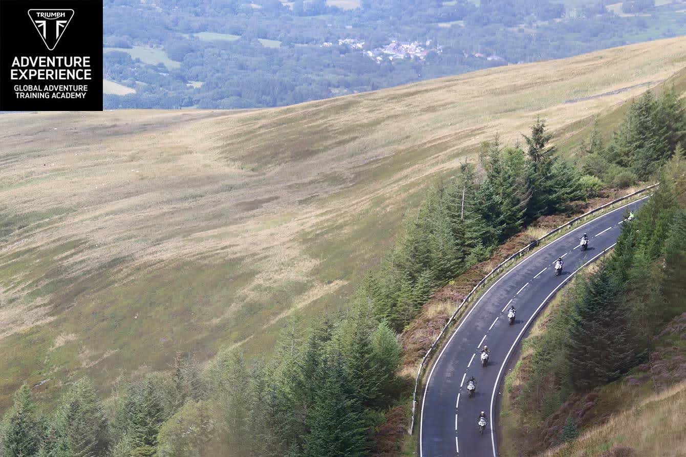 Logo display on a landscape view of the riders on Triumph Tiger range along a scenic route