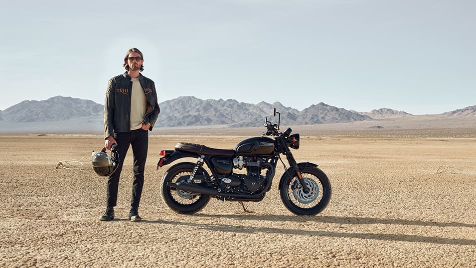 Triumph Bonneville T120 with person stood beside the motorbike