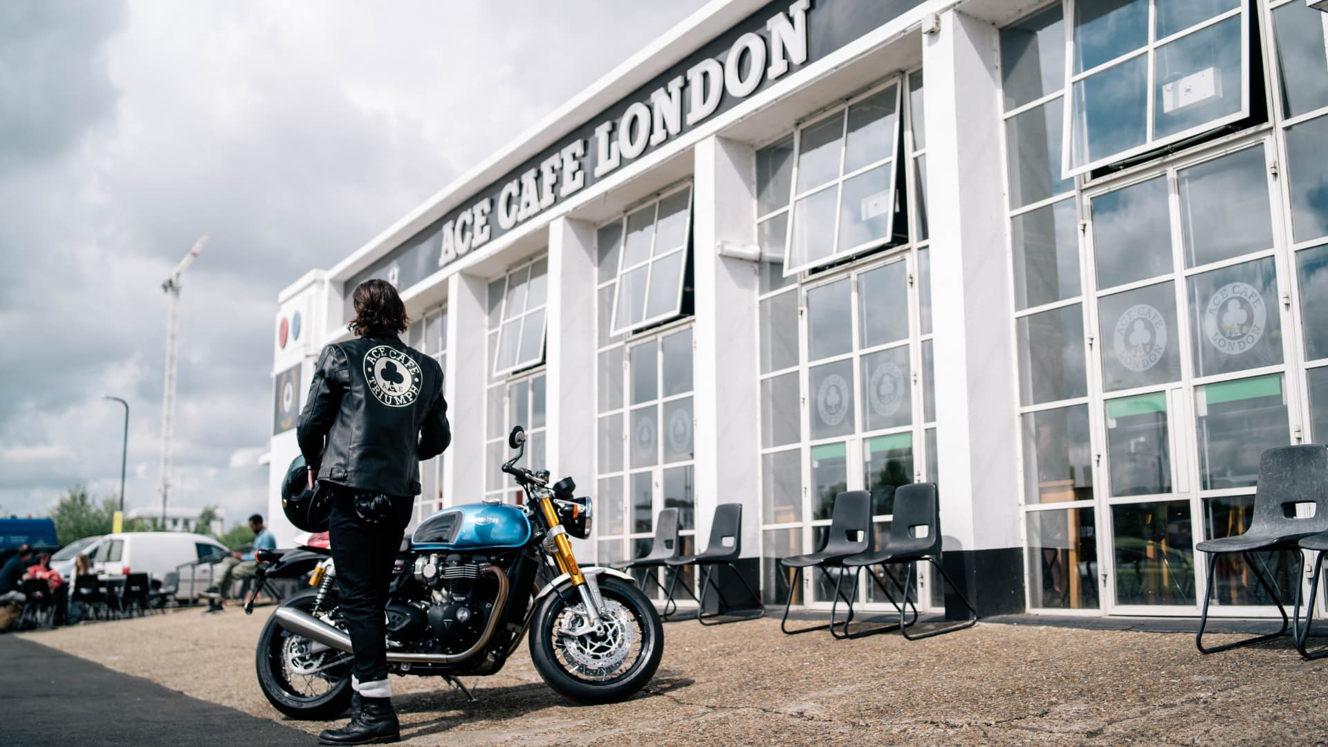 Man wearing Ace Cafe Triumph Leather Jacket Walking into Cafe