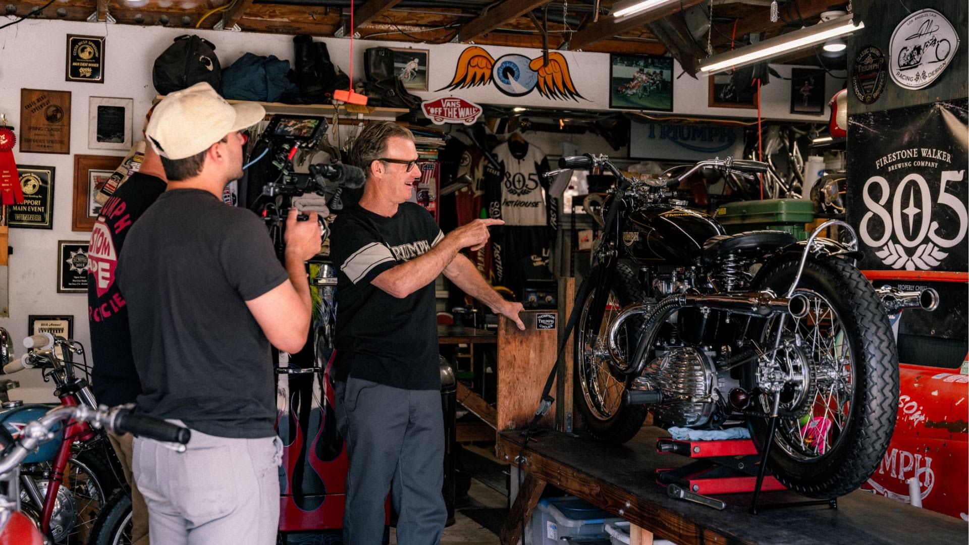Bryan Thompson Interview looking at Triumph Bike in garage