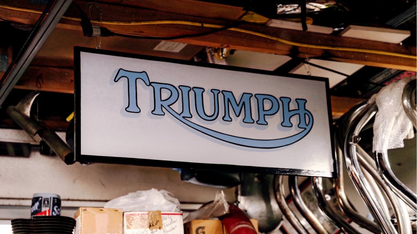 Large White Triumph Sign in garage