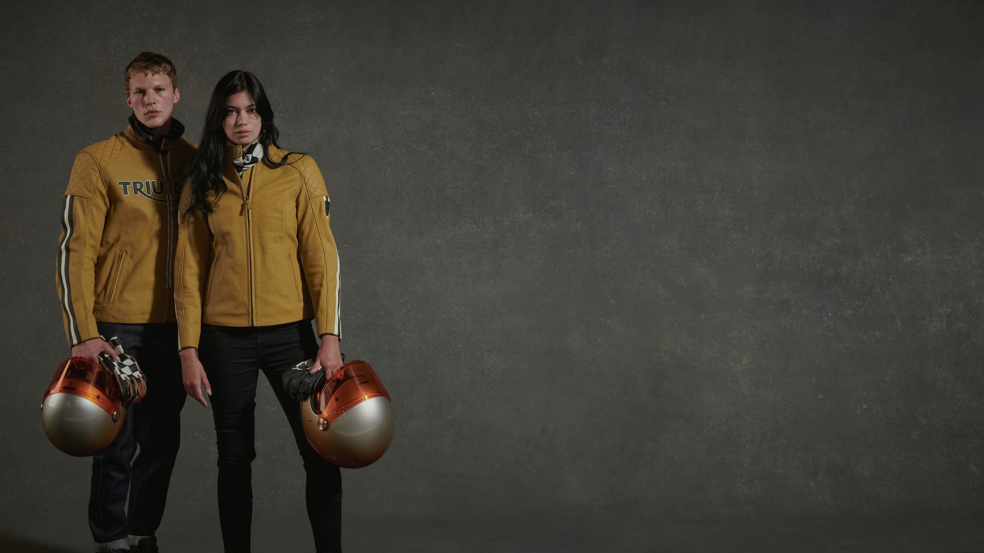 Male and Female model wearing gold Triumph Braddan jackets)