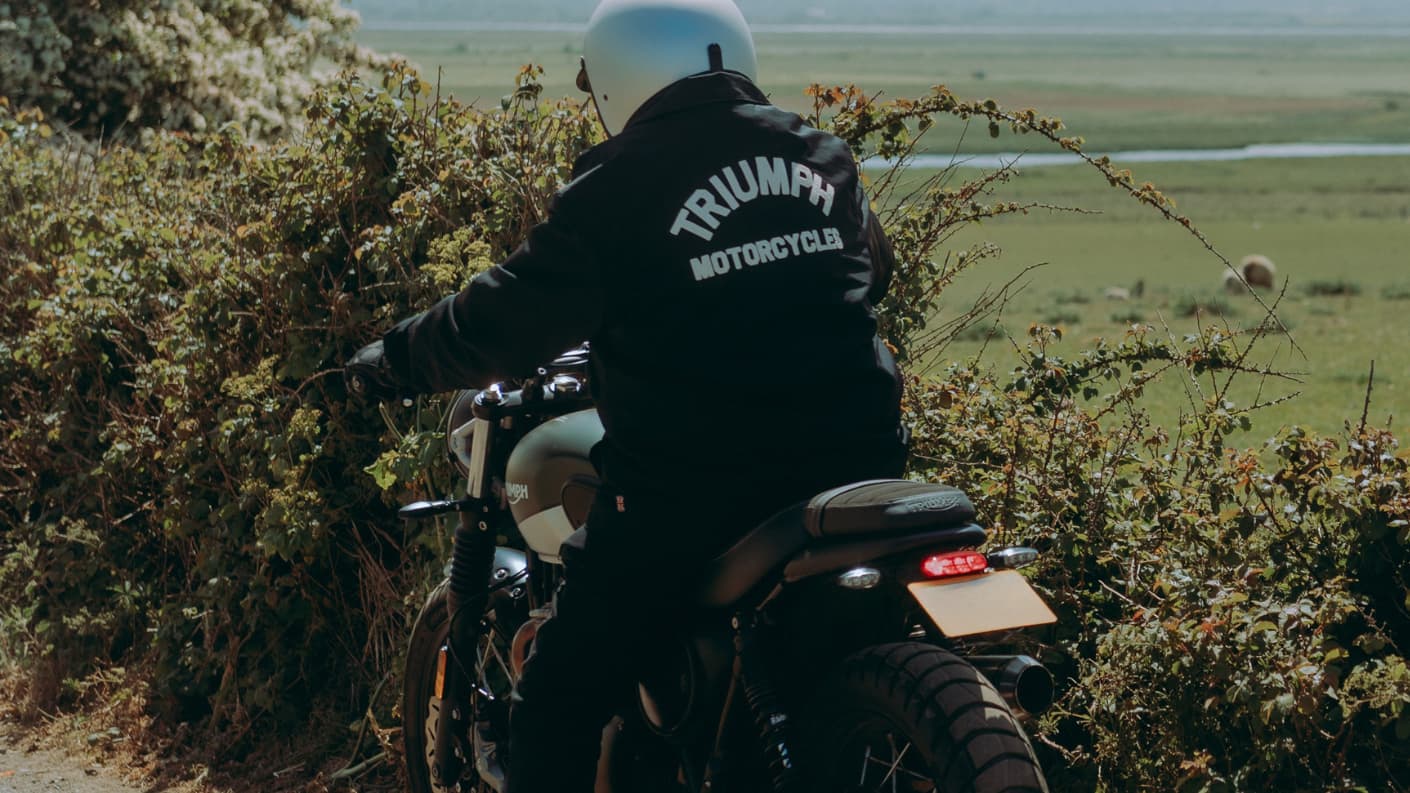 Man on Triumph Bike wearing Carter Coach Jacket