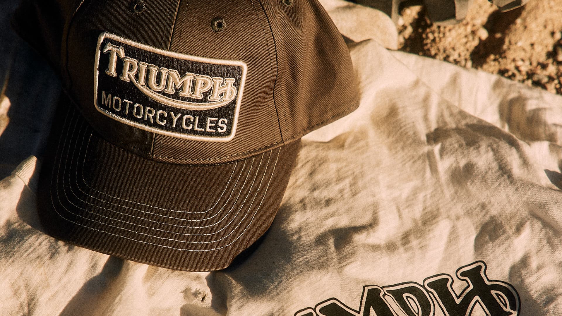 Close up of Triumph Heritage cap and tee