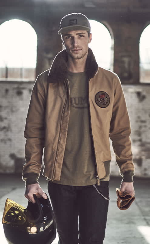 a man in a khaki winter jacket with faux fur collar