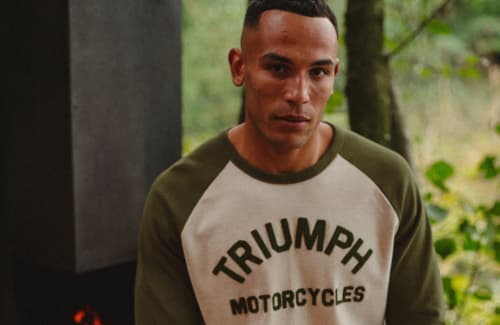 Man sitting in woods wearing Triumph Randalby Tee