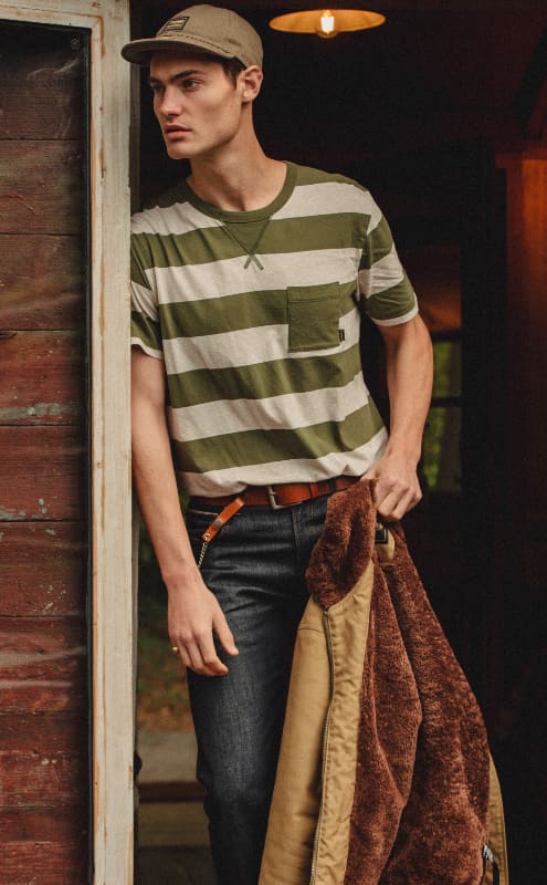 Man wearing Triumph Lifestyle Bratt Striped tee in forest
