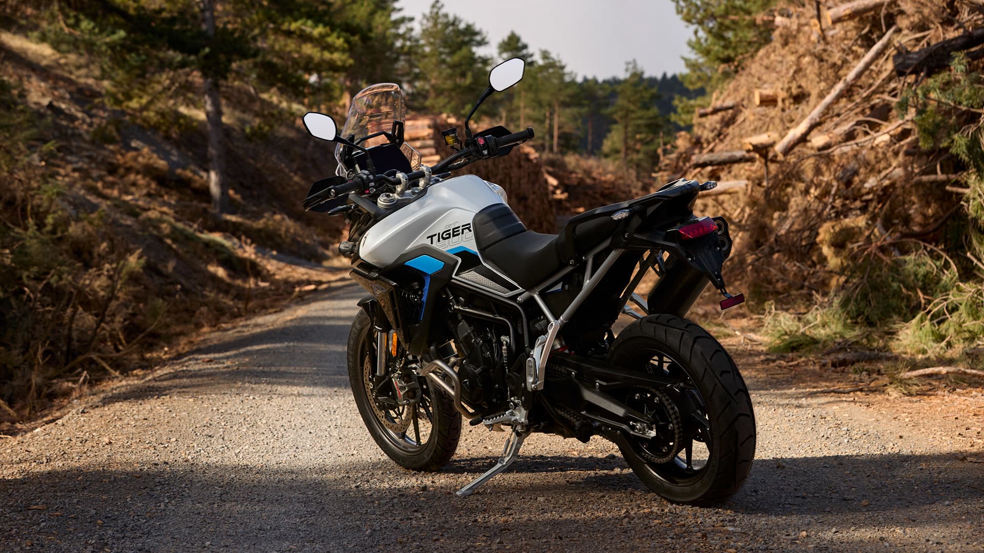 Angled rear side view of parked Triumph Tiger 900 GT Pro Alpine Edition