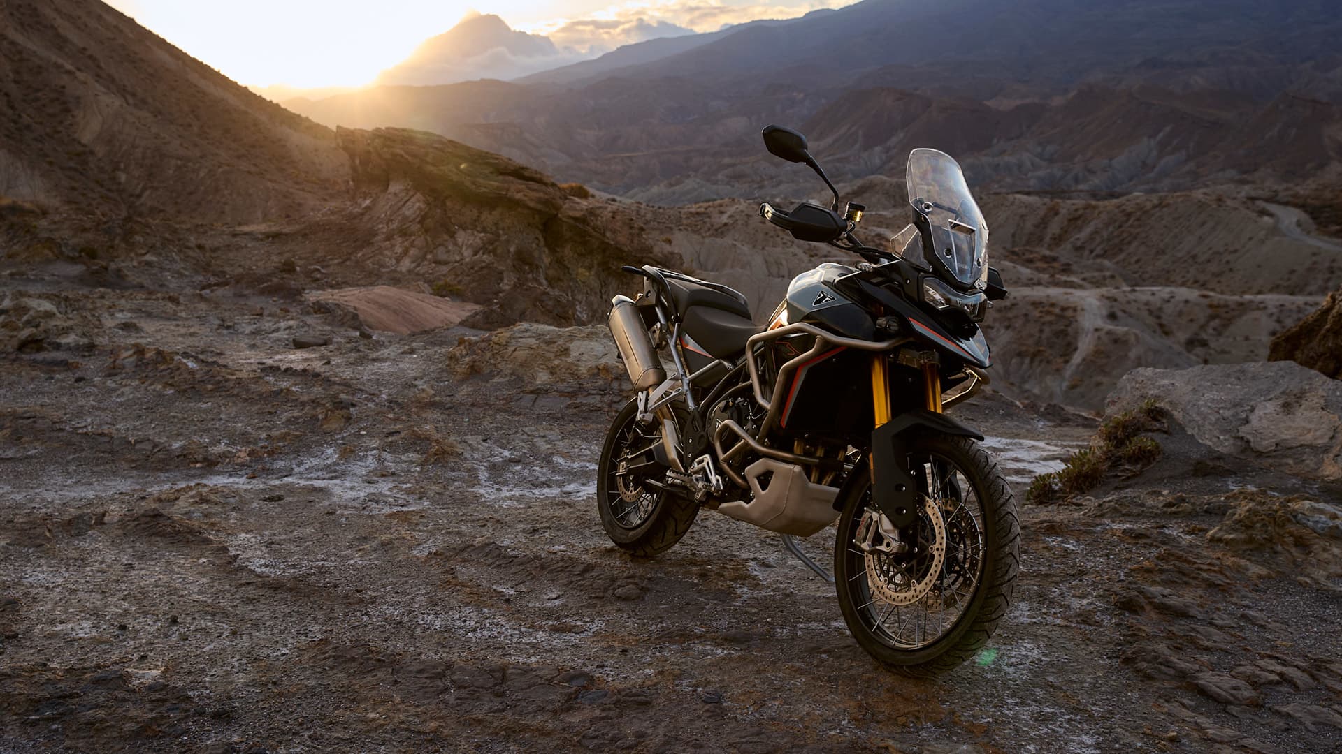 Triumph Tiger 900 Desert Edition parked on a rocky hill