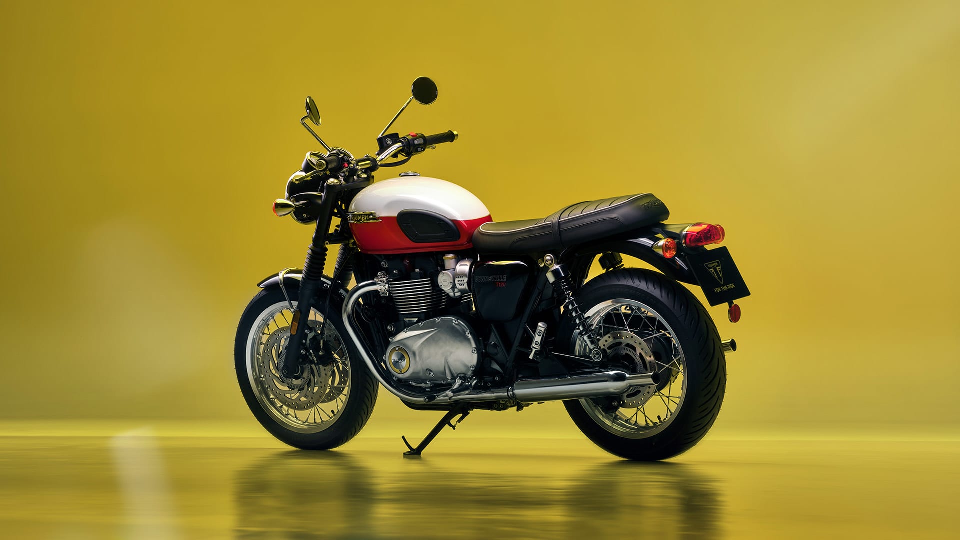 Triumph Bonneville T120 MY25 with a yellow background