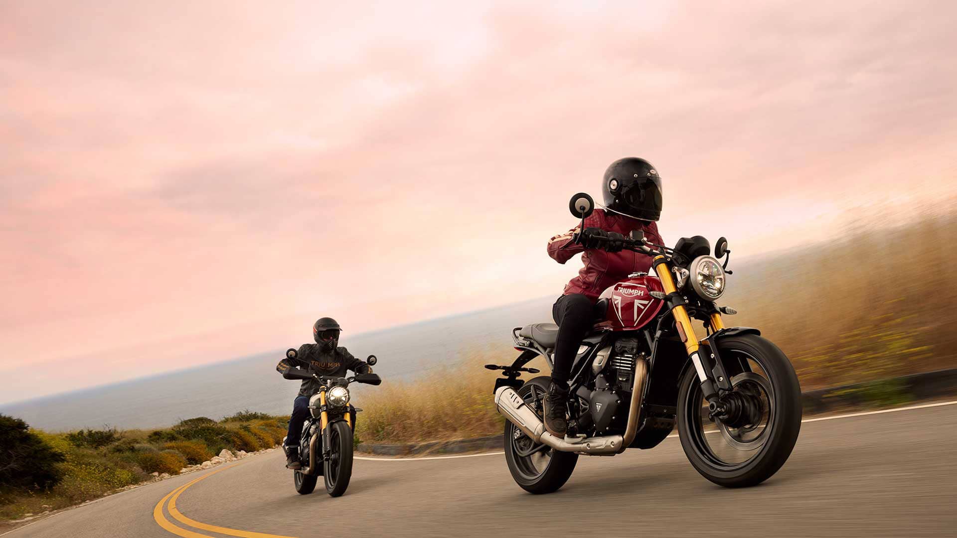 Riders on Triumph Speed 400 and Scrambler 400 X up a road