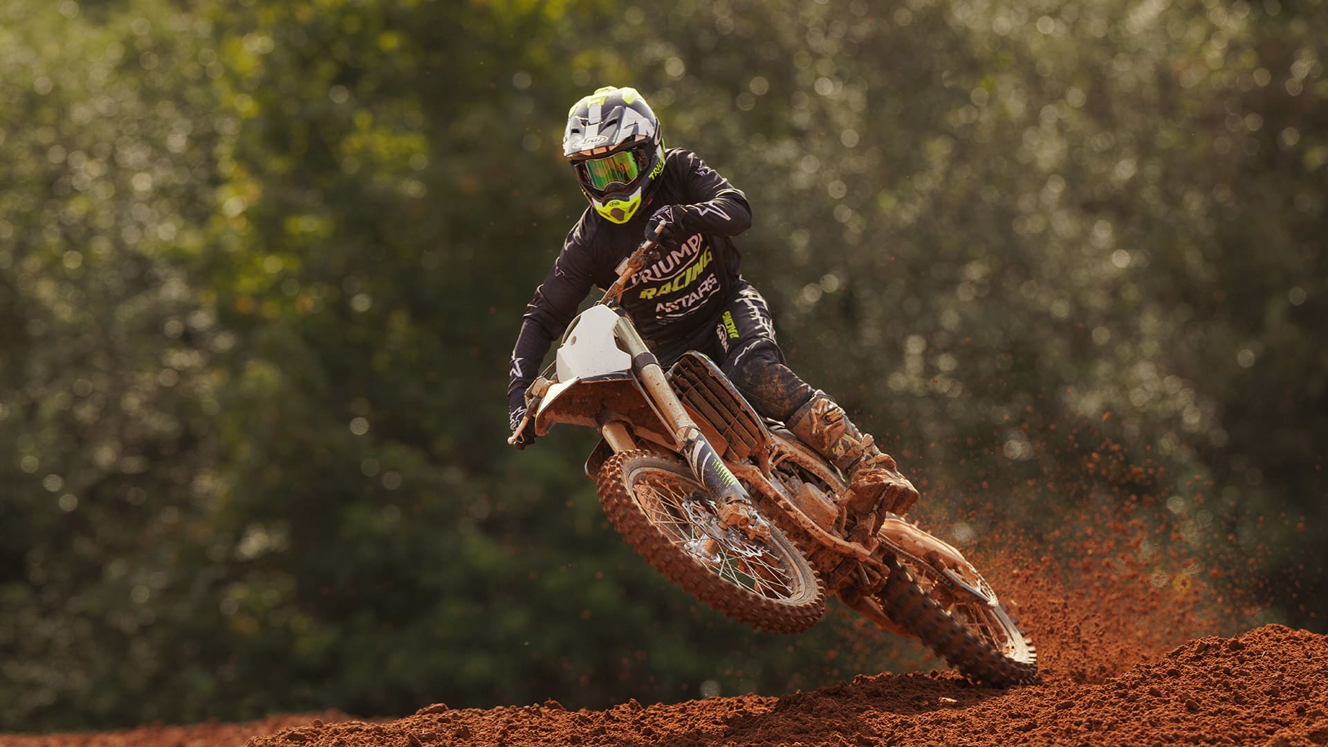 Rider on Triumph TF 250-X through muddy track