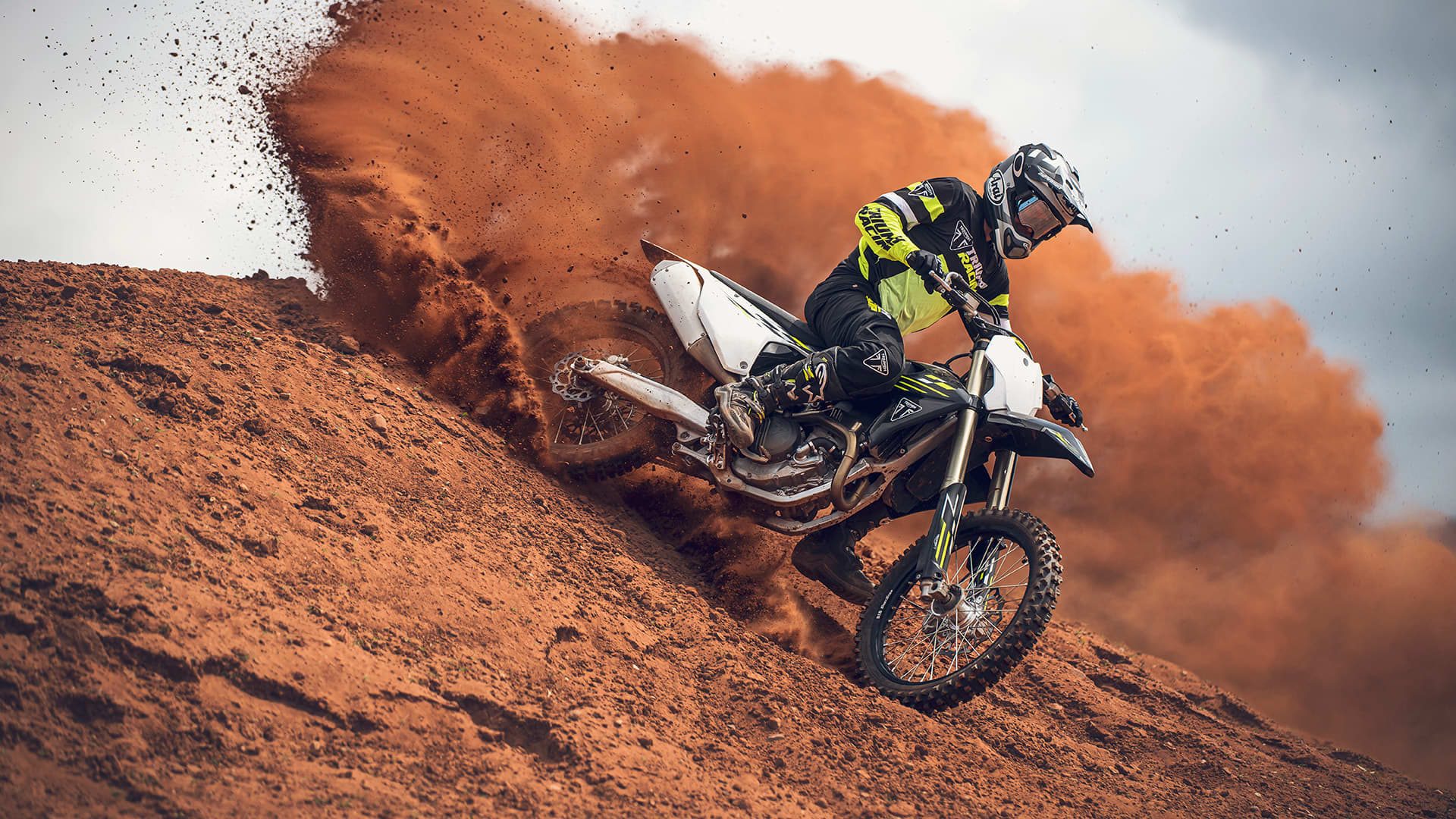 Rider on Triumph TF 250-X MY26 going through muddy track