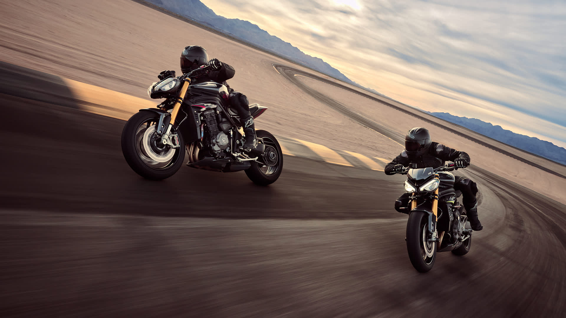 Action shot of Triumph Speed Triple 1200s side by side 