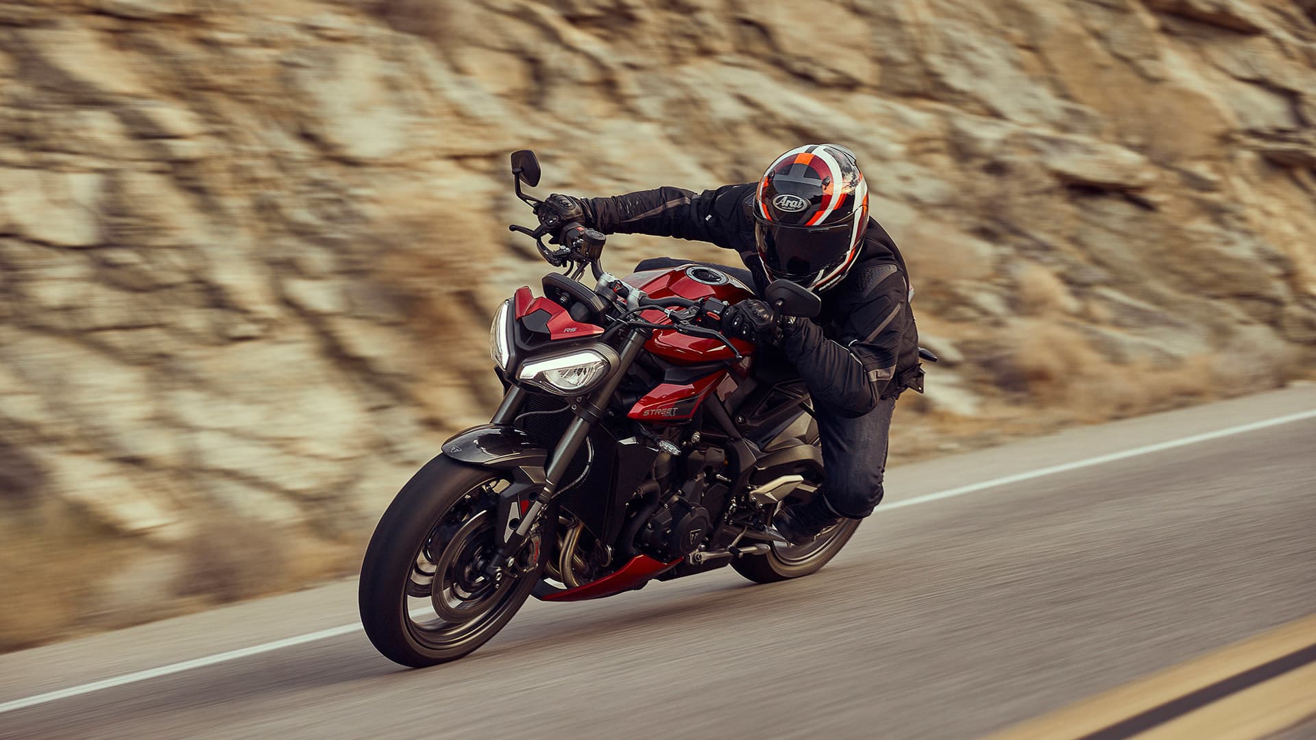 Rider on Triumph Street Triple RS in Carnival red