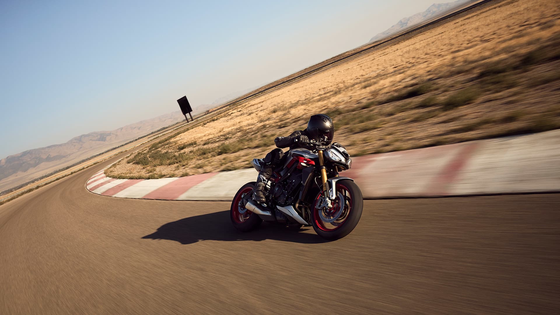Rider on Triumph Street Triple 765 RX on a track