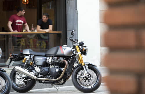 The new Triumph Thruxton RS in Matt Storm Grey & Matt Silver Ice parked in urban area