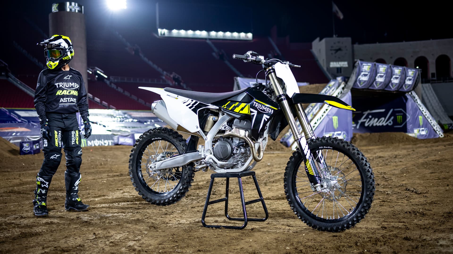 Triumph TF250 X on stand and racer in  Triumph motocross outfit