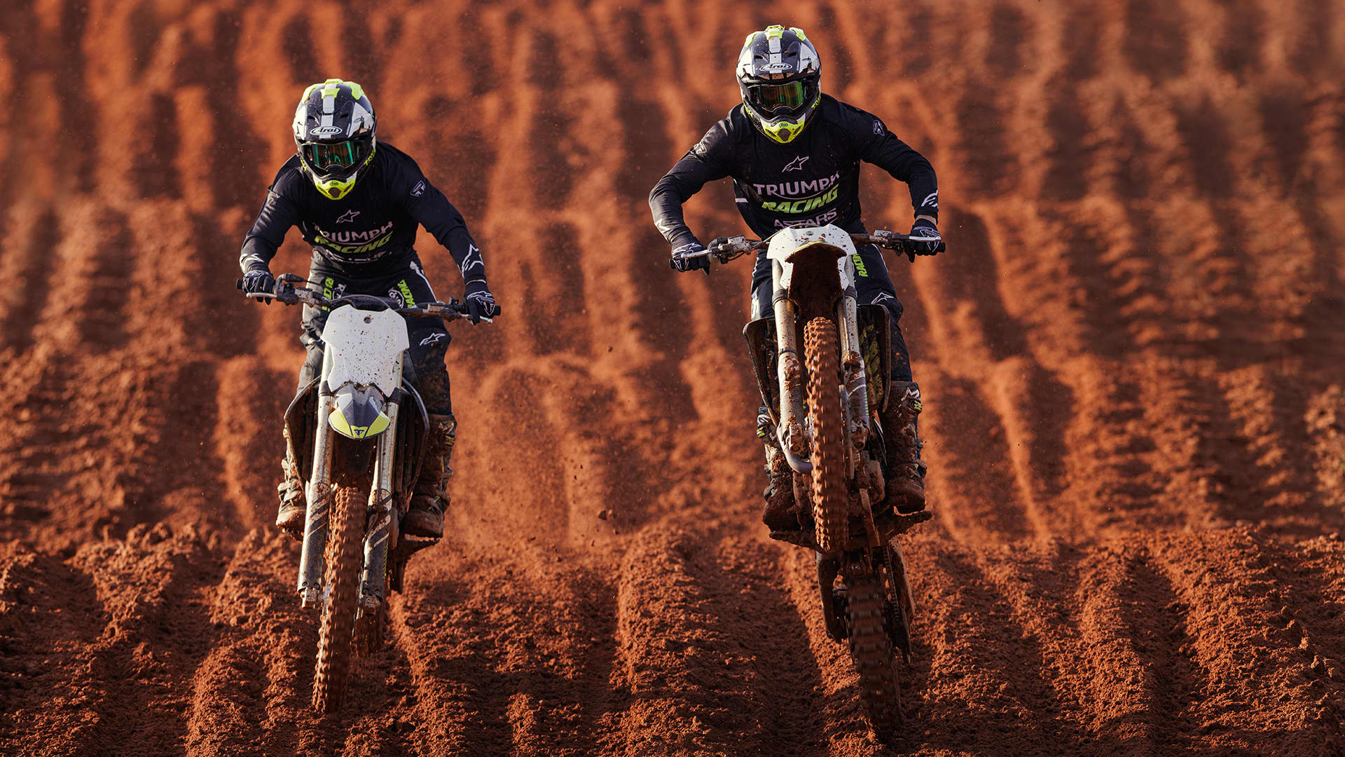 two riders onboard Triumph TF 250-Xs riding on Motocross track