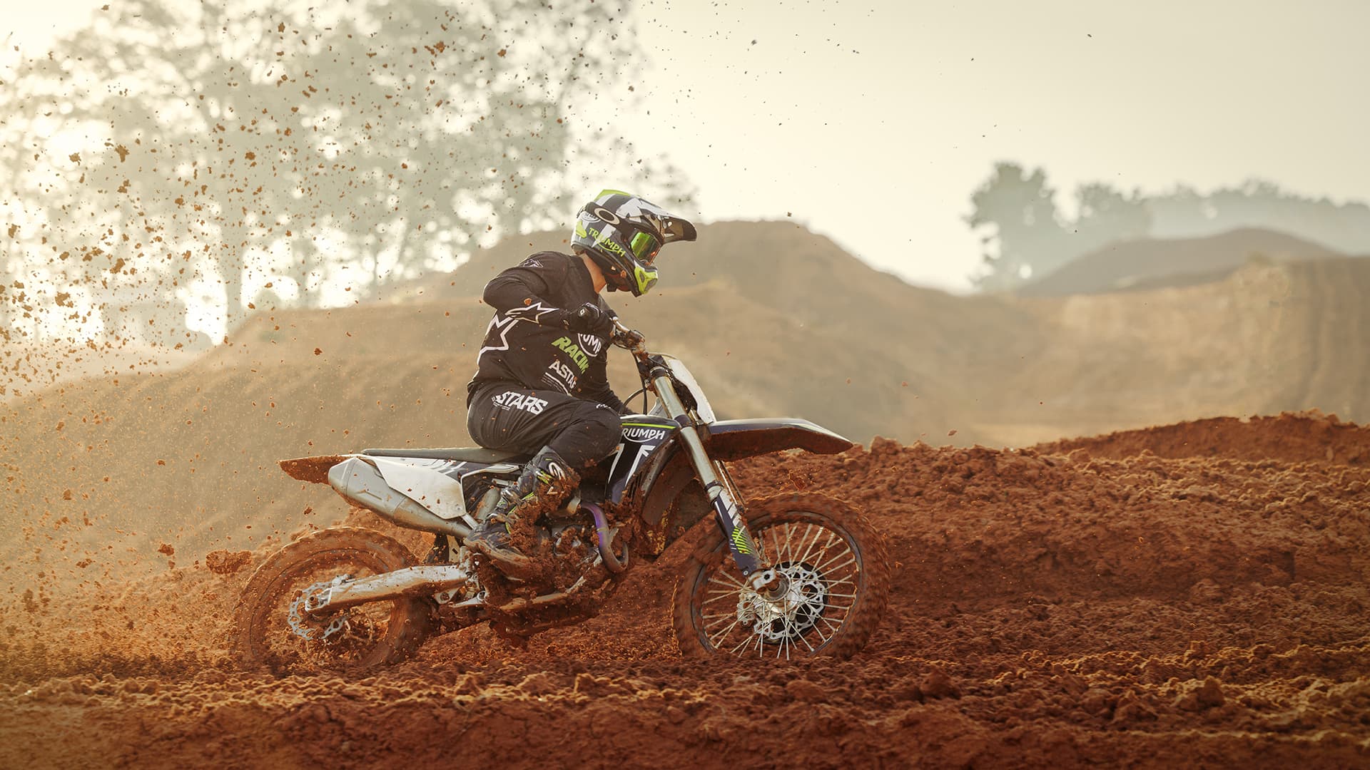 Rider onboard Triumph TF 250-Xs riding on Motocross track