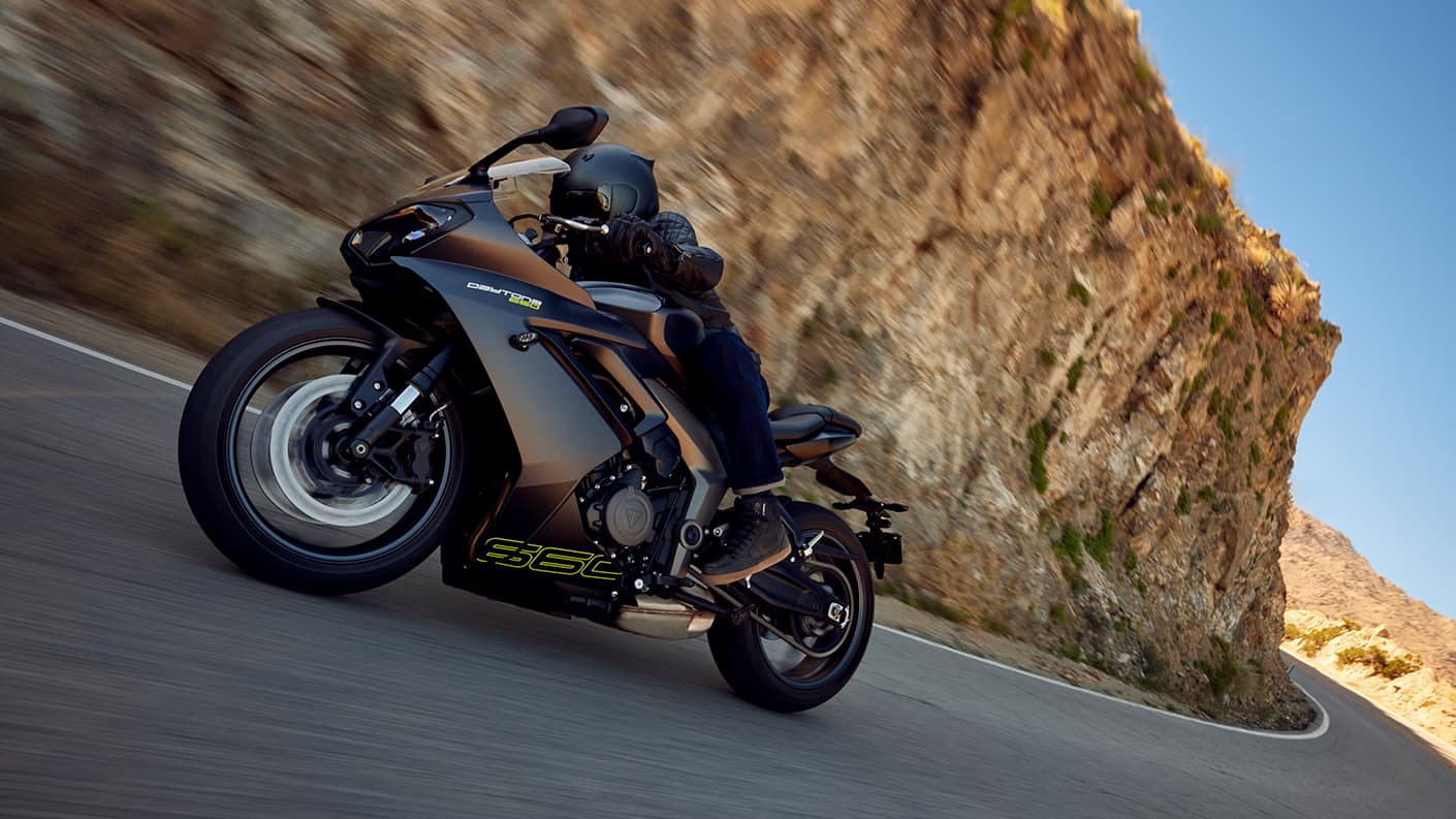 Triumph Daytona 660 in satin granite and satin jet black riding on mountain road
