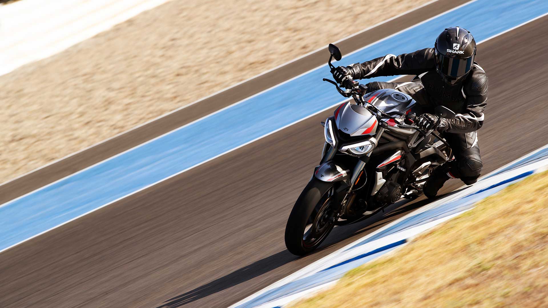 Action shot of Triumph Street Triple RS in Silver Ice  on a racetrack bend