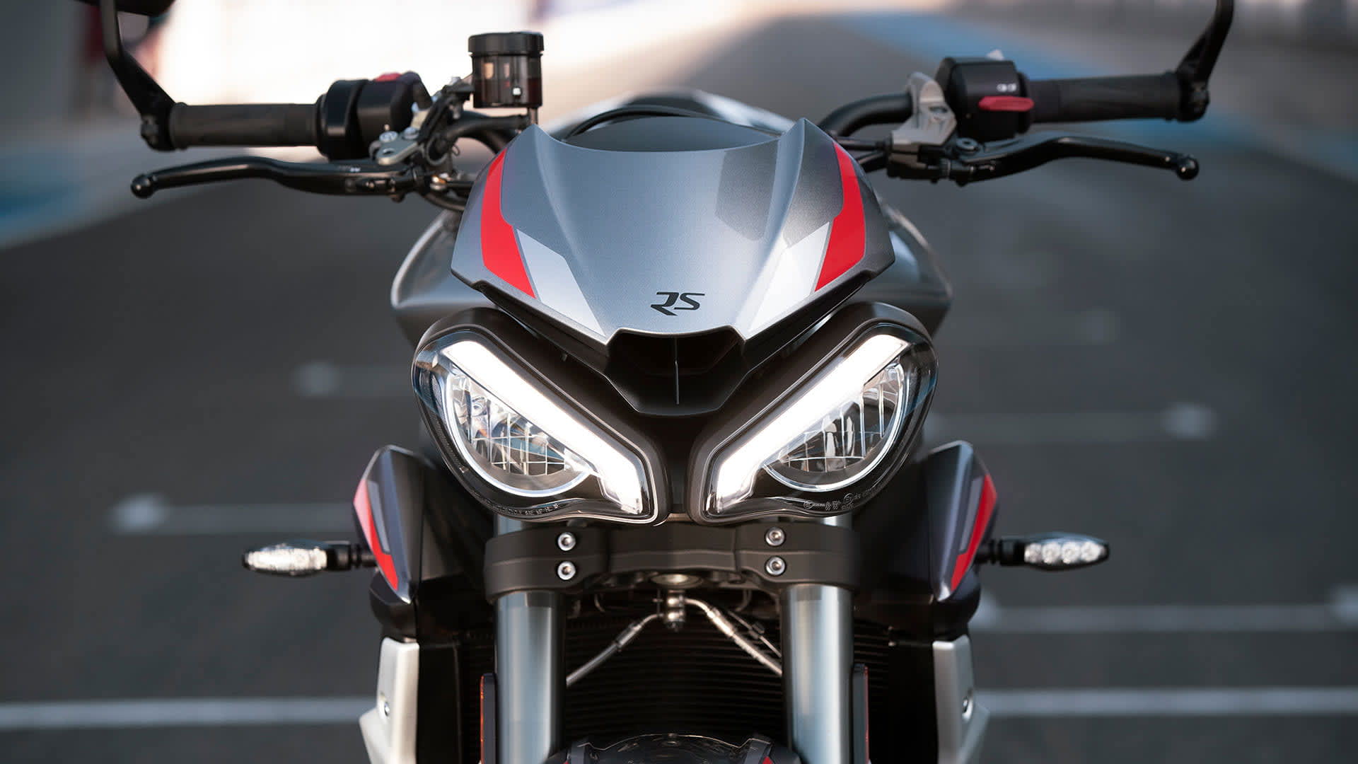 Close-up front shot of Triumph Street Triple RS in Silver Ice beautifully distinctive full-LED twin headlight
