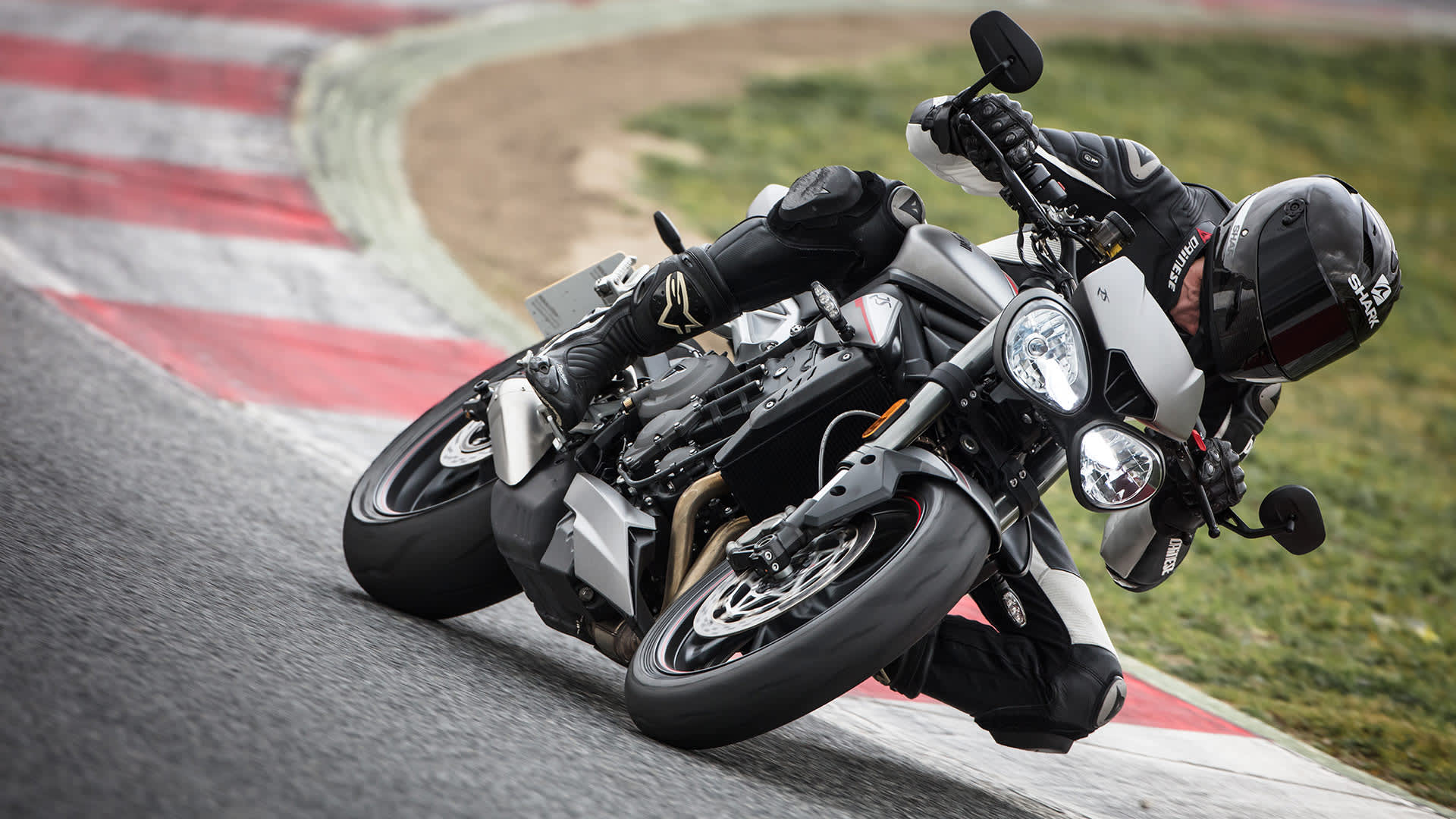 Triumph Street Triple motorcycle going round racetrack bend
