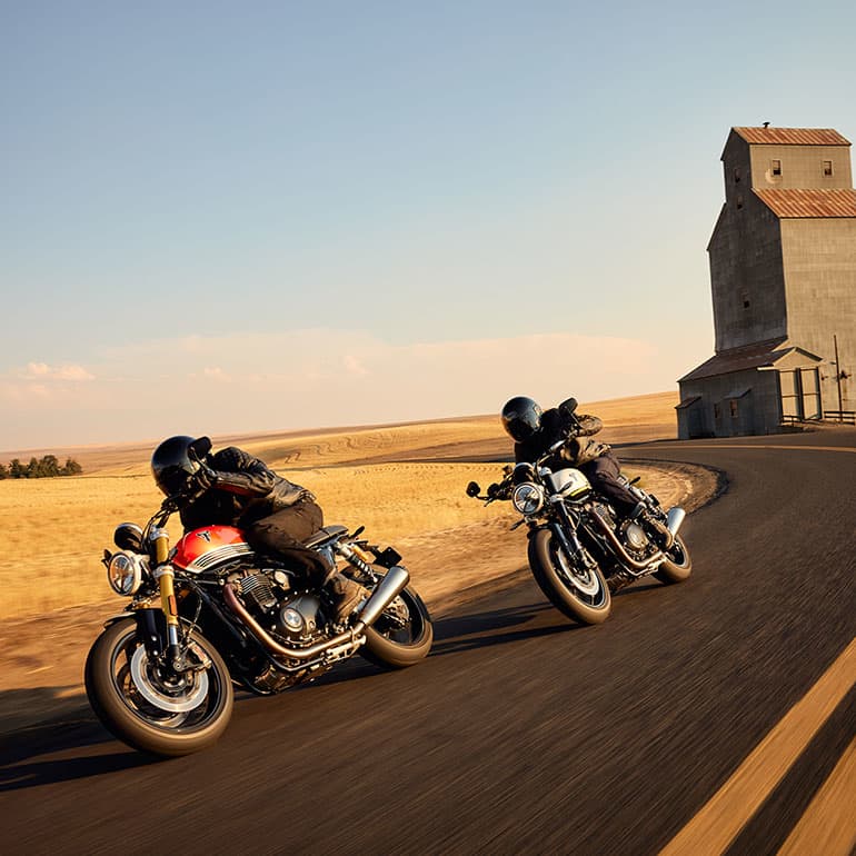 Triumph Speed Twin 1200 and RS bikes riding shot on the road