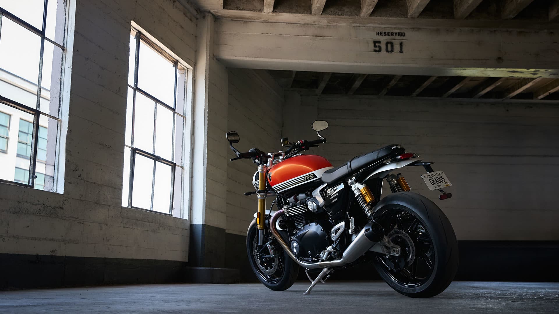 Triumph Speed Twin 1200 RS parked next to a window