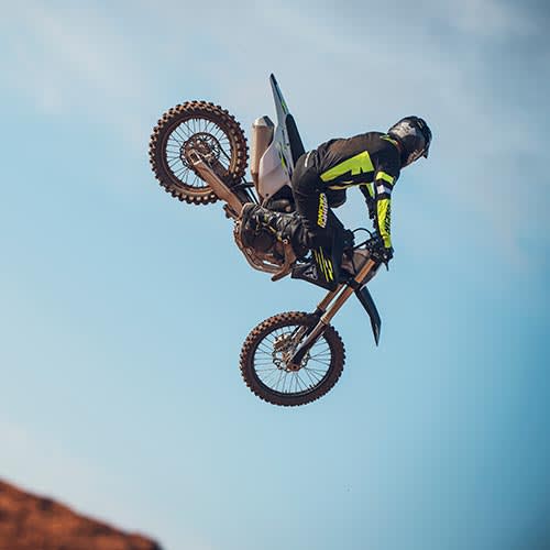 MY26 Triumph TF 250-X rider doing a jump