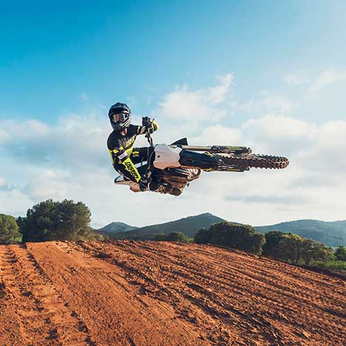 Triumph TF 450-X with rider performing an advanced jump