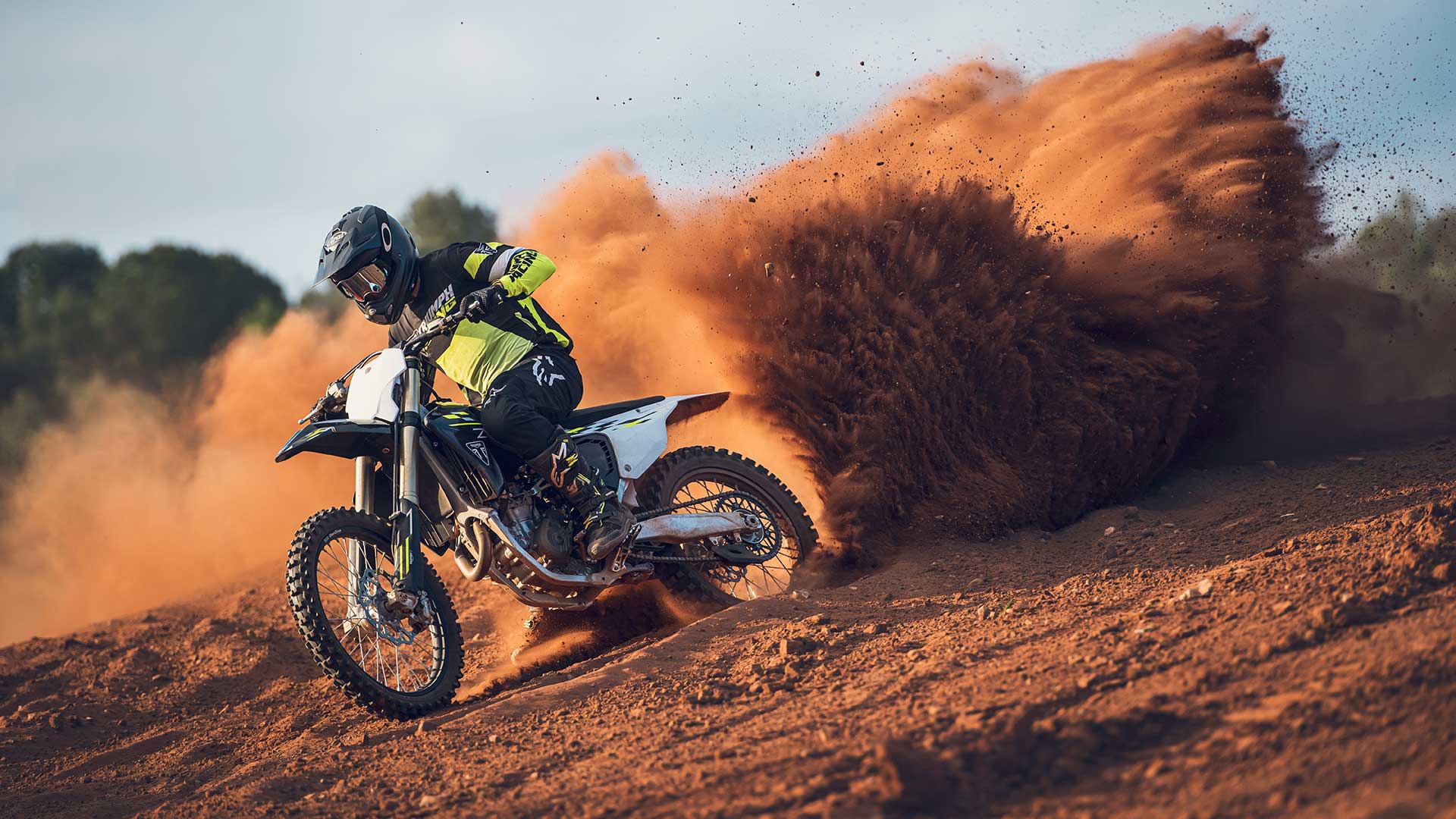 TF 450-X riding out of a dirt cloud