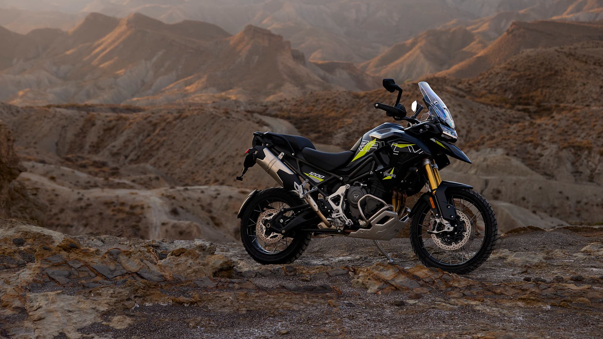 Triumph Tiger 1200 Desert with rocky mountains in the background