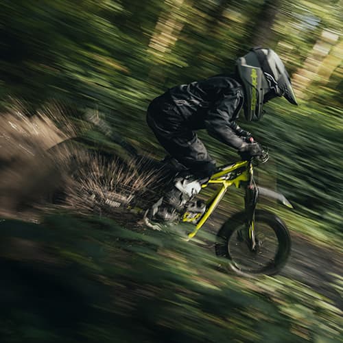 TXP-16 powered by OSET bike riding swiftly through a forest