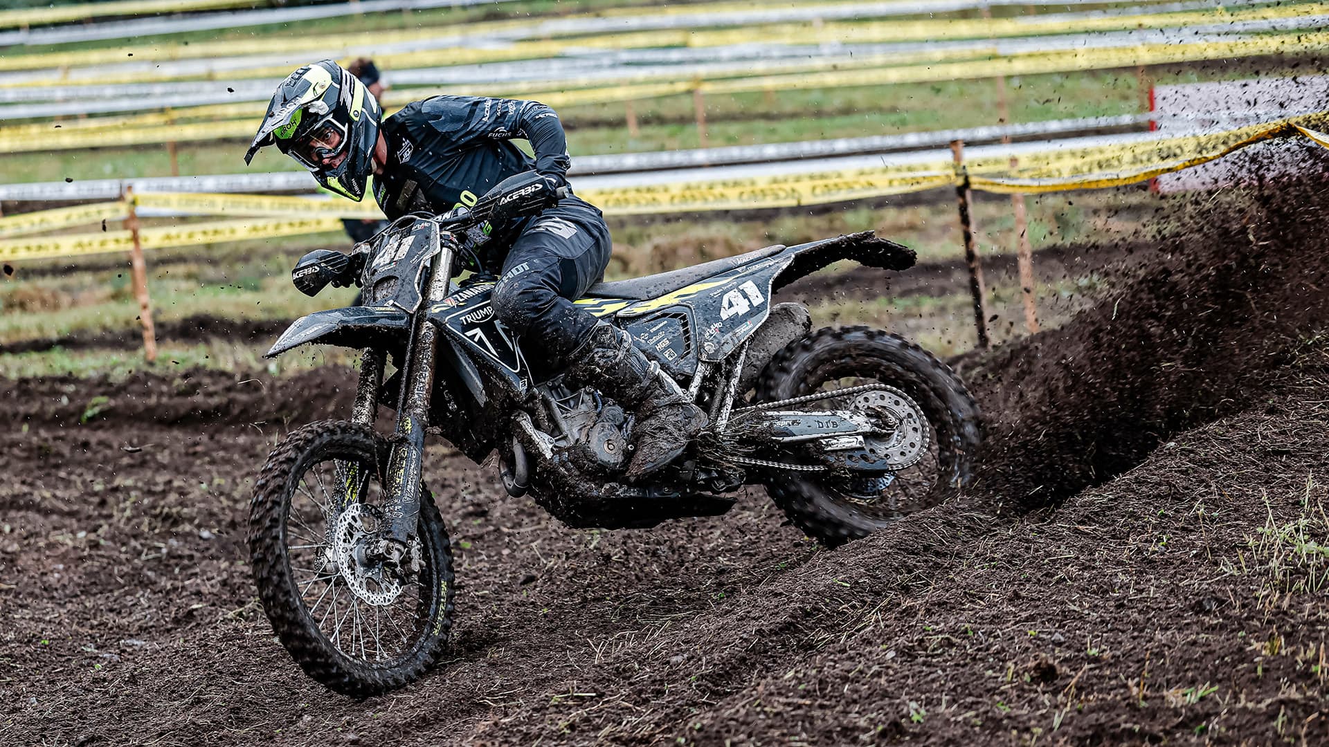 Man riding Triumph TF 250-E on muddy track