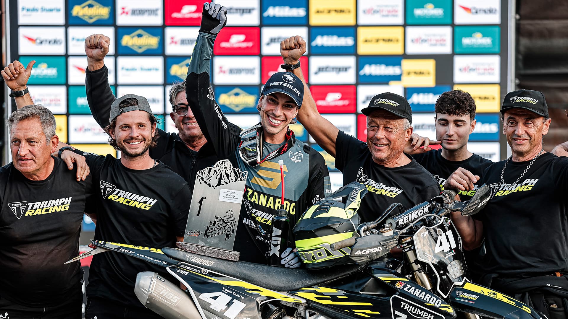 Group of men celebrating victory at EnduroGP 