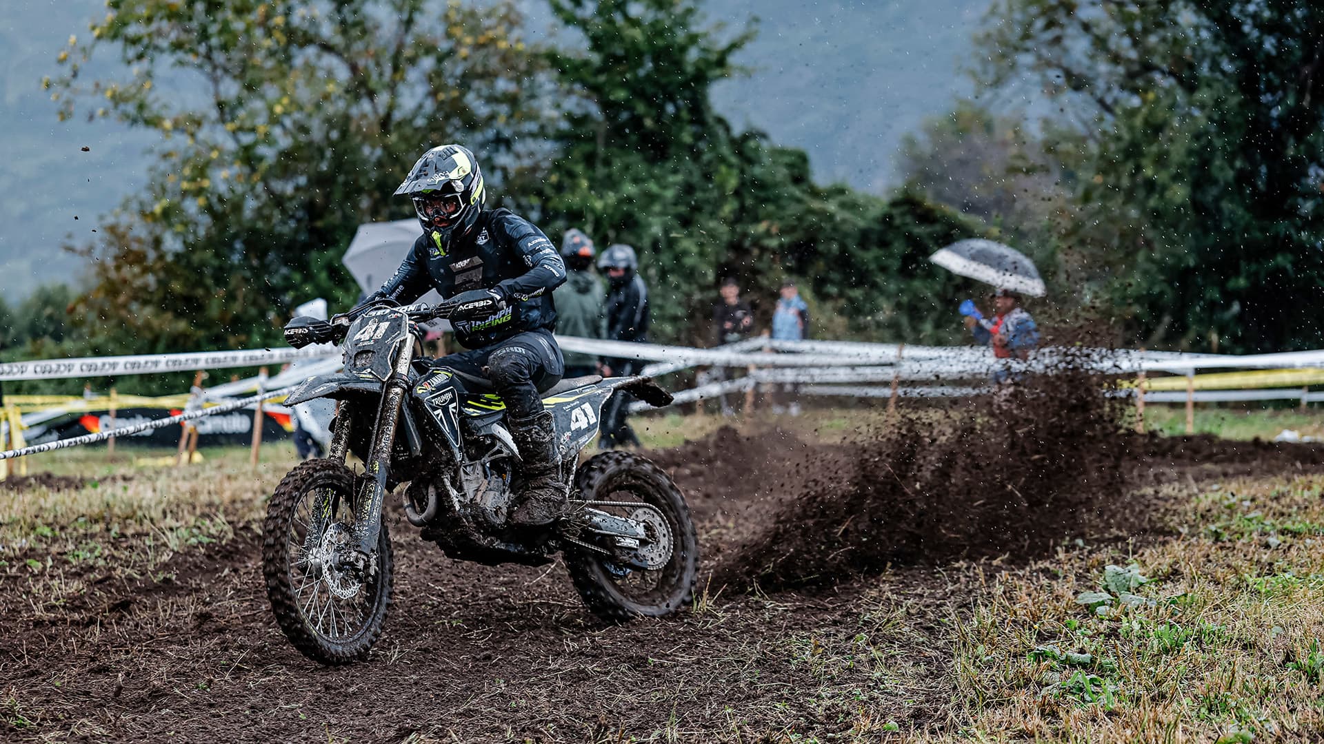 Man riding TF 250-E through muddy track