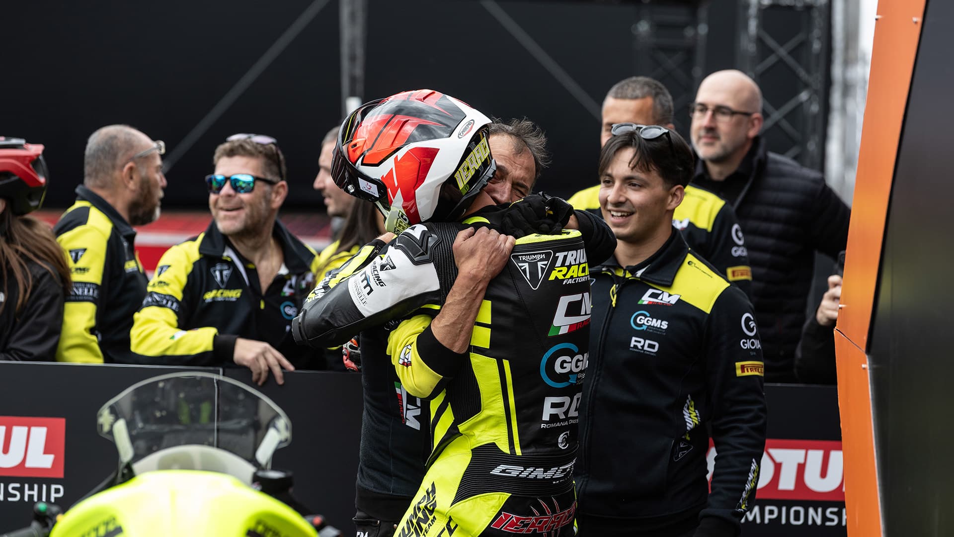 Rider hugging another individual