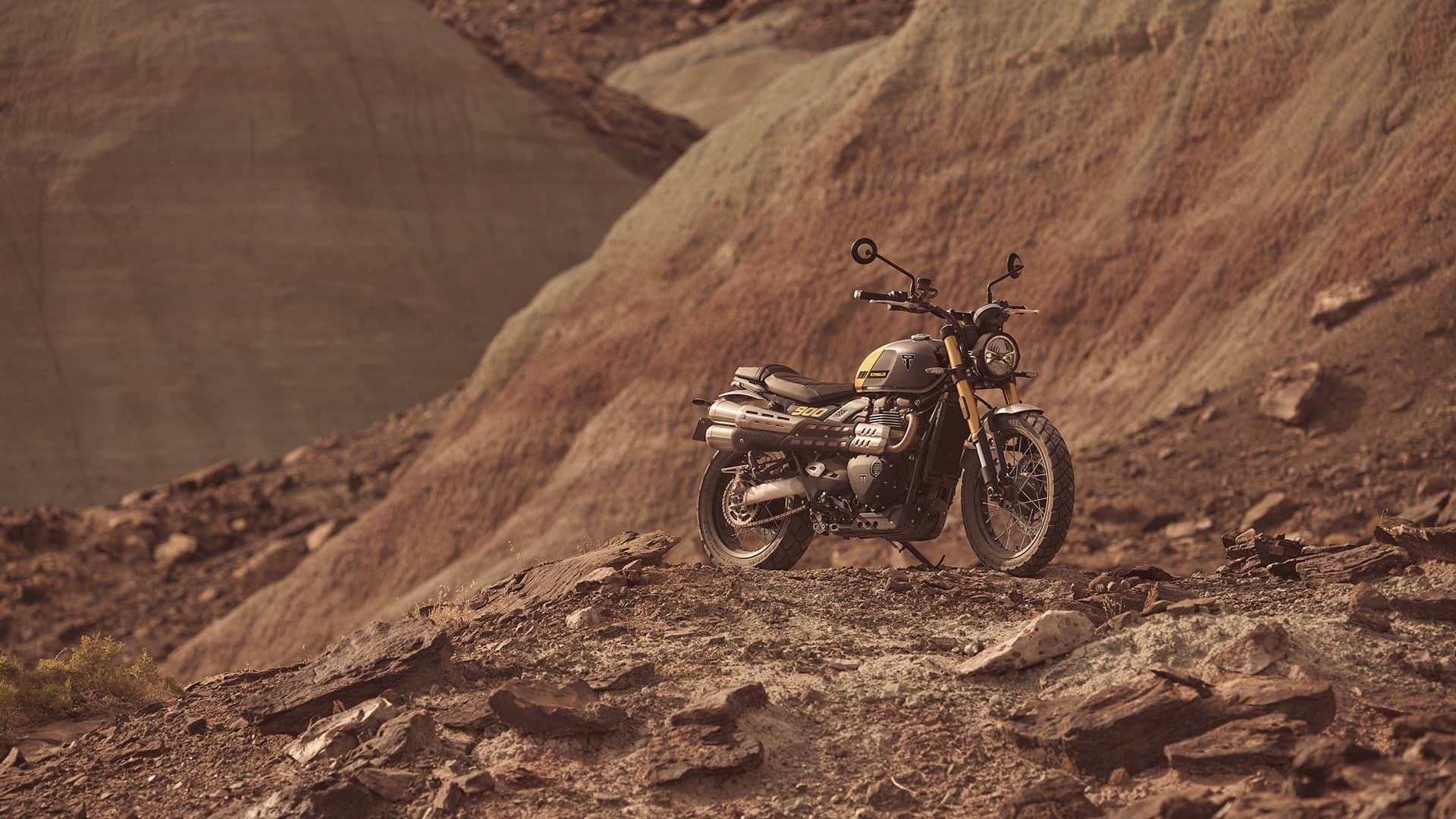 Triumph Scrambler 900 on rocky and dusty hill