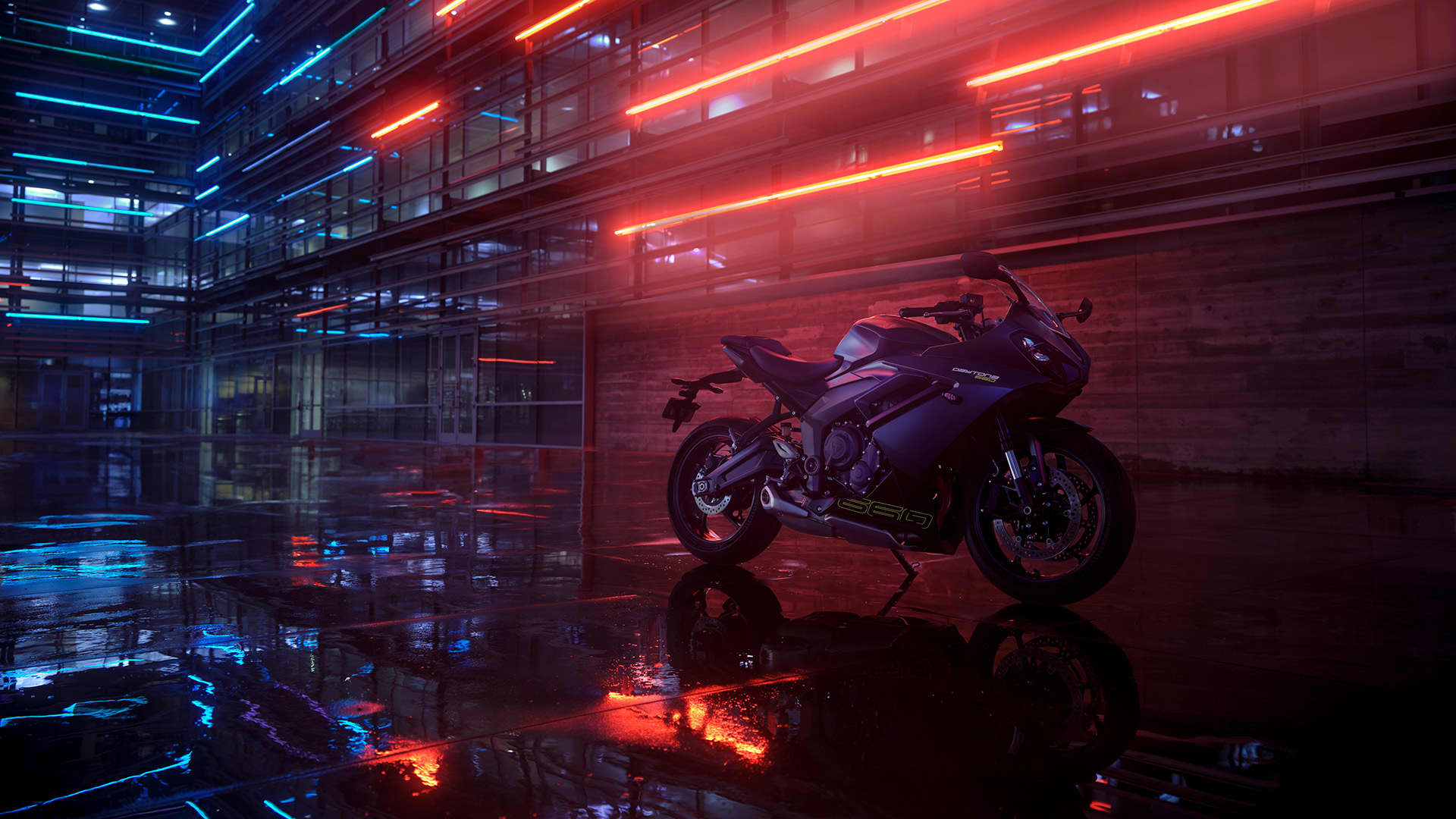 Stationary Triumph Daytona 660 with red LEDs in the background