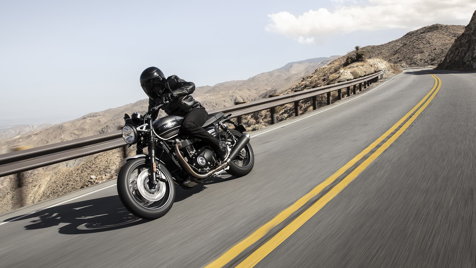 Triumph Speed Twin riding through mountain roads