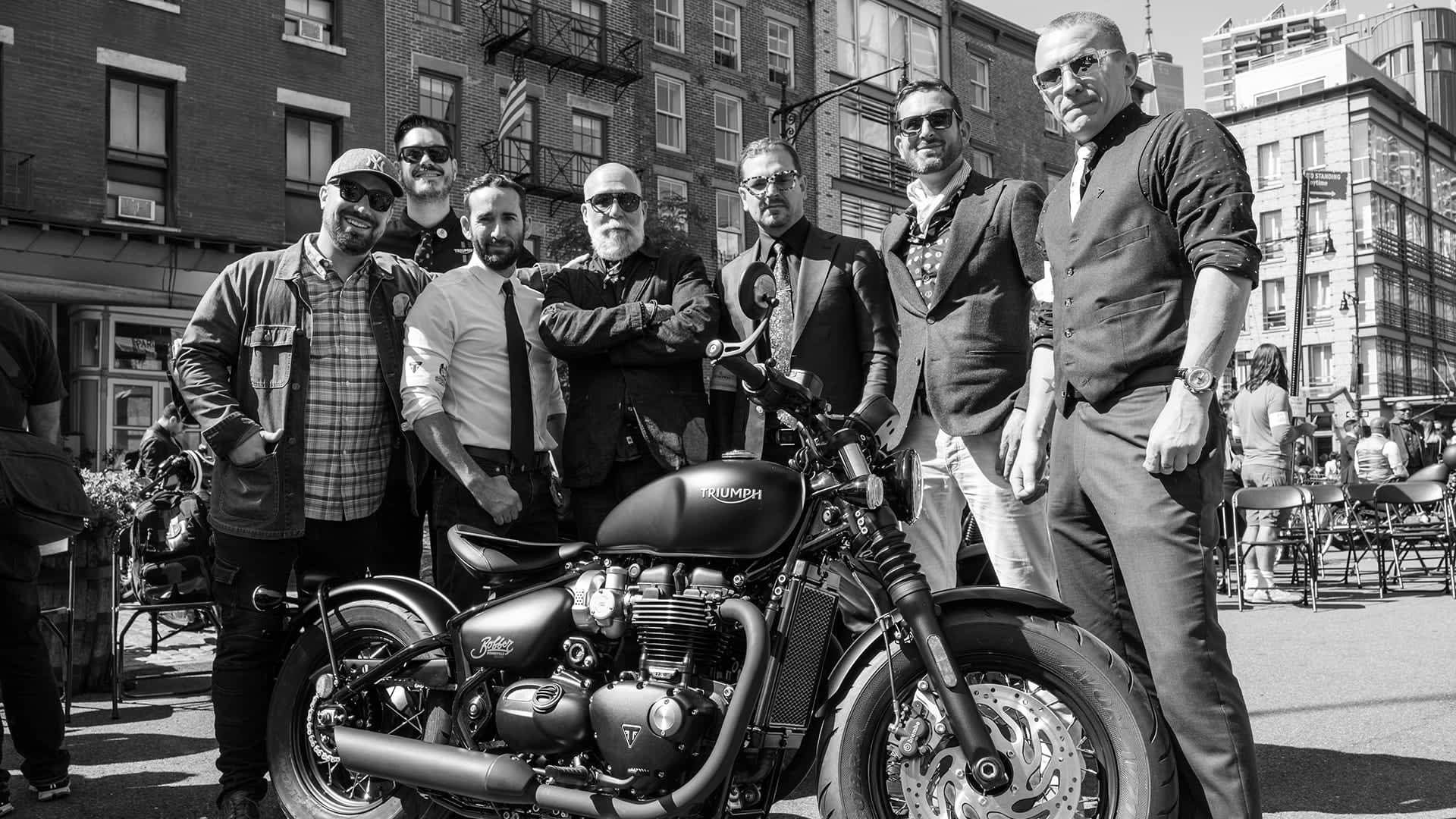 Distinguished gentlemen ready for their ride with Triumph in shot