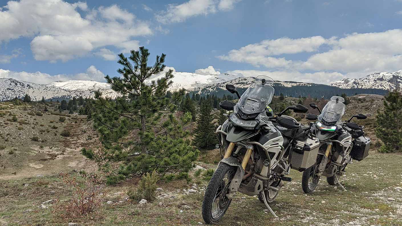 Tiger 1200 Rally Pro with mountains in the background