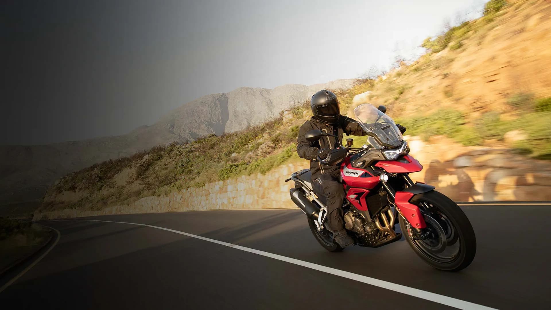 Korosi Red Triumph Tiger 900 GT Pro on a road-going adventure