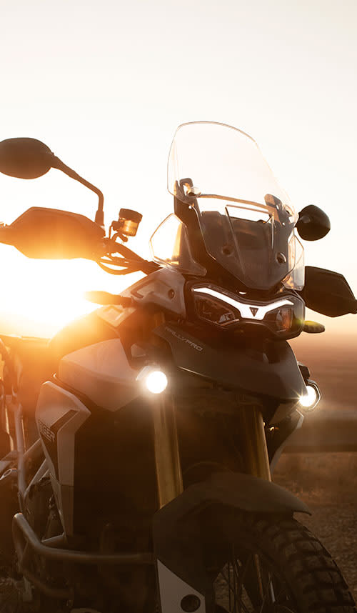 Close-up of a Triumph Tiger Rally Pro at sunrise